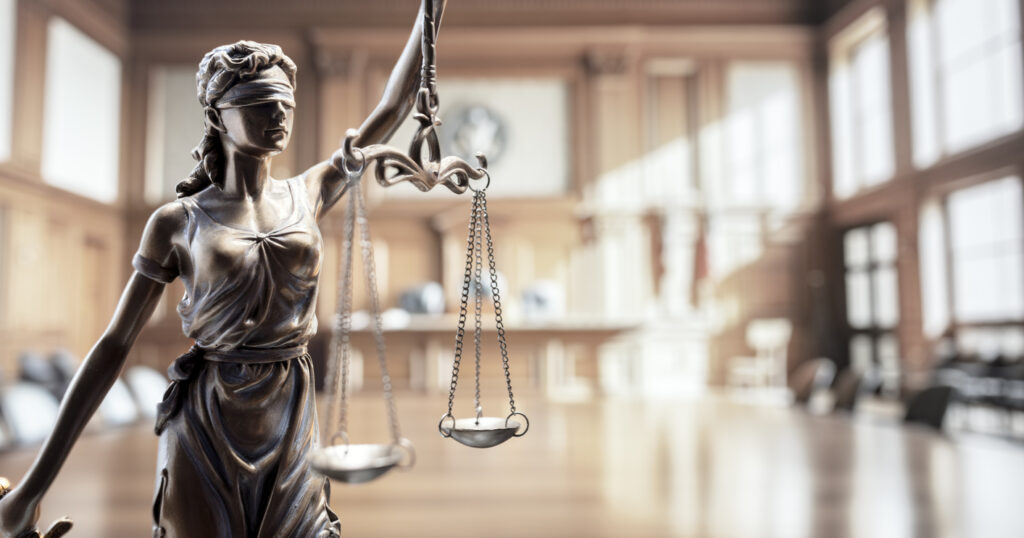 Legal and law concept statue of Lady Justice with scales of justice in court room background